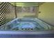 A luxurious hot tub is nestled in a lattice enclosure with a brick accent wall for added privacy at 584 Cherokee Ne St, Marietta, GA 30060