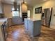 Modern kitchen with stainless steel appliances, center island with granite countertop, and tiled backsplash at 584 Cherokee Ne St, Marietta, GA 30060