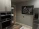 Stylish kitchen featuring stainless steel appliances, stone countertops, and a gray wall at 584 Cherokee Ne St, Marietta, GA 30060