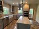 Well-lit kitchen featuring a center island, stainless appliances, and updated cabinets at 584 Cherokee Ne St, Marietta, GA 30060