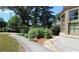 Garden view with brick walkway, flower beds, and trees near the side of the house at 584 Cherokee Ne St, Marietta, GA 30060