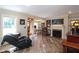 Bright living room featuring a fireplace, wood floors, transom window and view to dining area at 584 Cherokee Ne St, Marietta, GA 30060