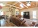 Open living room features vaulted ceiling, hardwood floors, leather seating, and a large TV at 584 Cherokee Ne St, Marietta, GA 30060