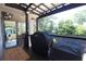 Covered porch with grills and a small wooden table at 584 Cherokee Ne St, Marietta, GA 30060