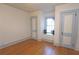 An empty room with light blue trim, hardwood floors, and two paneled doors at 584 Cherokee Ne St, Marietta, GA 30060