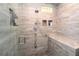 Beautiful walk-in shower with stone floor, glass door, and stone bench seating at 584 Cherokee Ne St, Marietta, GA 30060