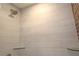 Shower features sleek white tiling, glass shelving, and a modern shower head at 584 Cherokee Ne St, Marietta, GA 30060