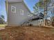 The house's backyard shows a deck, stairs, and large open area at 68 Silverthorne Pass, Douglasville, GA 30134