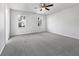 Clean bedroom featuring new carpet, a ceiling fan, and ample natural light at 68 Silverthorne Pass, Douglasville, GA 30134