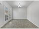 Bright dining room featuring neutral walls, contemporary chandelier, and a door to the outdoors at 68 Silverthorne Pass, Douglasville, GA 30134