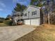 Charming exterior elevation with a two-car garage, a partial deck, and a blue color palette at 68 Silverthorne Pass, Douglasville, GA 30134