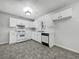 Bright kitchen features white cabinets, modern appliances, and durable floors at 68 Silverthorne Pass, Douglasville, GA 30134