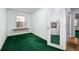 Bright bedroom featuring green carpet, a window, and a door with a mirror at 231 Holly Springs Ne Rd, White, GA 30184