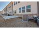 A modern townhouse backyard features a concrete patio, AC unit, and white vinyl siding above a brick foundation at 2777 Lou Lou Ln, Buford, GA 30519