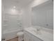 Bathroom featuring a single sink, toilet, shower and tub combination, plus wood-look flooring at 2777 Lou Lou Ln, Buford, GA 30519