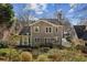 Back exterior of home featuring a manicured yard and stone patio at 4164 Gateswalk Se Dr, Smyrna, GA 30080