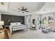 Tranquil main bedroom with tray ceilings, a ceiling fan, and large windows providing ample natural light at 4164 Gateswalk Se Dr, Smyrna, GA 30080