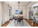 Stylish dining area with modern lighting, stainless steel appliances, and hardwood floors at 540 Woodall Ne Ave, Atlanta, GA 30306