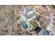 Stunning aerial view showcasing the backyard pool, patio, and lush landscaping of this private residence at 5430 Burdette Se Rd, Mableton, GA 30126