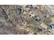 Wide aerial view highlighting the home's location nestled among mature trees and large lots in a quiet neighborhood at 5430 Burdette Se Rd, Mableton, GA 30126