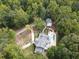 Expansive aerial view of the property showing a secluded home site surrounded by lush, mature trees and an inground pool at 5430 Burdette Se Rd, Mableton, GA 30126