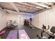Finished basement gym area with fitness equipment, yoga mats and bright, fun lighting at 5430 Burdette Se Rd, Mableton, GA 30126