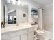 Bright bathroom featuring white cabinets and a shower-tub combo at 5430 Burdette Se Rd, Mableton, GA 30126