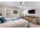 Bedroom featuring a large TV, a dresser with drawers and multiple windows for natural lighting at 5430 Burdette Se Rd, Mableton, GA 30126