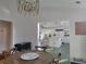 Bright dining area features a modern chandelier and offers a view of the well-appointed kitchen with a tile floor at 5430 Burdette Se Rd, Mableton, GA 30126