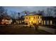 Stately home with elegant columns and dark shutters, beautifully lit up at dusk showcasing its classic charm at 5430 Burdette Se Rd, Mableton, GA 30126