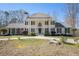 Elegant two-story home boasts a columned facade and circular driveway, enhancing its grand presence and curb appeal at 5430 Burdette Se Rd, Mableton, GA 30126