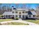 Stately white brick home featuring a columned front porch and manicured landscaping creating a welcoming curb appeal at 5430 Burdette Se Rd, Mableton, GA 30126