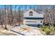 Two-story garage with a driveway and basketball hoop, set amidst mature trees at 5430 Burdette Se Rd, Mableton, GA 30126