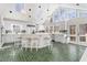 Bright kitchen with white cabinets, large island, and unique green brick flooring at 5430 Burdette Se Rd, Mableton, GA 30126