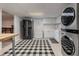 Laundry area with modern appliances, black-and-white rug, and adjacent kitchenette at 5430 Burdette Se Rd, Mableton, GA 30126