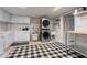 Bright laundry room with stacked washer/dryer, modern sink, and plenty of cabinet space at 5430 Burdette Se Rd, Mableton, GA 30126