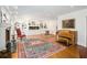 Spacious living room with fireplace, custom shelving, hardwood floors, and a vintage piano at 5430 Burdette Se Rd, Mableton, GA 30126