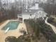 Backyard view highlighting an inviting in-ground pool, manicured landscaping, and outdoor seating area at 5430 Burdette Se Rd, Mableton, GA 30126