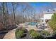 Backyard pool surrounded by a beautifully landscaped yard and ample seating area at 5430 Burdette Se Rd, Mableton, GA 30126