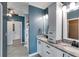 The en-suite bathroom showcases double sinks with granite counters and white cabinets plus tile floors at 363 Safe Harbor Dr, Dallas, GA 30157