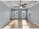 The primary bedroom features light blue walls, white trim, tray ceiling, and light hardwood floors at 363 Safe Harbor Dr, Dallas, GA 30157