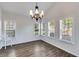 Bright dining room with ample windows, modern chandelier, and wood floors at 363 Safe Harbor Dr, Dallas, GA 30157