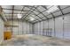 Spacious garage with concrete floors, metal walls, and overhead lighting, providing ample storage and workspace at 363 Safe Harbor Dr, Dallas, GA 30157
