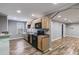 Kitchen with modern appliances, wood cabinets, an eat-in space, and wood flooring at 363 Safe Harbor Dr, Dallas, GA 30157