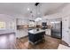 This gourmet kitchen features a granite island, stainless appliances, tile backsplash and shaker cabinets at 363 Safe Harbor Dr, Dallas, GA 30157
