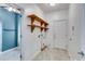 The laundry room features tile floors, wood shelving, and leads to the bathroom at 363 Safe Harbor Dr, Dallas, GA 30157