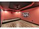 Finished theater room with hardwood floors, platform, custom paint, and ceiling fan at 363 Safe Harbor Dr, Dallas, GA 30157
