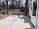 Concrete patio area, with a glimpse of grassy area and partially fenced yard at 3750 Clubhouse Se Ln, Conyers, GA 30094