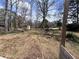 Expansive backyard featuring a storage shed and mature trees, offering a serene and private outdoor space at 3750 Clubhouse Se Ln, Conyers, GA 30094