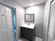 This bathroom has a vanity, framed mirror, and white walls at 3750 Clubhouse Se Ln, Conyers, GA 30094